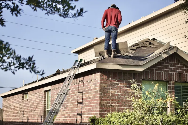 Professional roofer working on a residential roof in Italy
